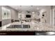 Open kitchen island features granite counters, stainless steel sink, and open view to the living room at 17437 W Via De Luna Dr, Surprise, AZ 85387
