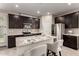 Stylish kitchen with stainless steel appliances and a granite island at 17437 W Via De Luna Dr, Surprise, AZ 85387
