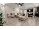 Open concept living room featuring modern furnishings and a ceiling fan at 17437 W Via De Luna Dr, Surprise, AZ 85387