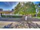 Charming backyard featuring a large tree, grassy lawn, and a covered patio with outdoor seating at 17668 N Del Webb Blvd, Sun City, AZ 85373