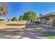 Spacious backyard with grass, mature trees, and a patio area, perfect for outdoor activities and relaxation at 17668 N Del Webb Blvd, Sun City, AZ 85373