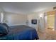 Cozy bedroom featuring a queen bed and view to the ensuite bathroom at 17668 N Del Webb Blvd, Sun City, AZ 85373