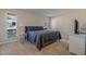 Comfortable bedroom with a king-sized bed, plush bedding, and lots of natural light from two windows at 17668 N Del Webb Blvd, Sun City, AZ 85373