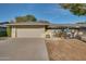 Charming single-story home with a two-car garage, beautiful plants, and inviting gated entrance at 17668 N Del Webb Blvd, Sun City, AZ 85373