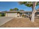 Charming home featuring mature trees, a well-maintained lawn, and a welcoming gated front entryway at 17668 N Del Webb Blvd, Sun City, AZ 85373