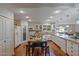 Expansive kitchen featuring white cabinets, stainless steel appliances, and island at 17668 N Del Webb Blvd, Sun City, AZ 85373