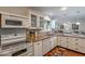 Functional kitchen area with granite countertops, white appliances, and lots of storage at 17668 N Del Webb Blvd, Sun City, AZ 85373
