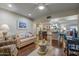 Open-concept living area featuring a modern kitchen and sleek hardwood floors and neutral colors at 17668 N Del Webb Blvd, Sun City, AZ 85373