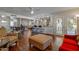 Spacious open-concept living area with dark wood floors, kitchen with bar seating, and a ceiling fan at 17668 N Del Webb Blvd, Sun City, AZ 85373