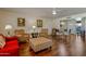 Bright living room with hardwood floors, stylish seating and a modern ceiling fan at 17668 N Del Webb Blvd, Sun City, AZ 85373