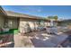 Comfortable patio with seating, an umbrella, a stone floor, and well-maintained landscaping at 17668 N Del Webb Blvd, Sun City, AZ 85373