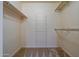 Bright walk-in closet with ample shelving and a carpeted floor for easy storage and organization at 17668 N Del Webb Blvd, Sun City, AZ 85373