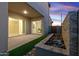 Covered back patio with a modern water feature and low-maintenance landscaping, offering a tranquil outdoor escape at 17831 W Mission Ln, Waddell, AZ 85355