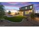 A well-manicured backyard with artificial turf and a fire pit, providing a tranquil outdoor space at 17831 W Mission Ln, Waddell, AZ 85355