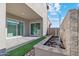 Covered back patio with a modern water feature and low-maintenance landscaping, providing a tranquil outdoor escape at 17831 W Mission Ln, Waddell, AZ 85355