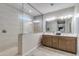 Modern bathroom with a glass-enclosed shower, double vanity, and stylish fixtures at 17831 W Mission Ln, Waddell, AZ 85355