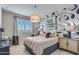 Bedroom featuring bold wallpaper, eclectic decor and a comfortable bed at 17831 W Mission Ln, Waddell, AZ 85355