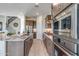 Modern kitchen features stainless steel appliances, granite countertops, and wood-look flooring at 17831 W Mission Ln, Waddell, AZ 85355