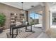 Office space with modern decor, a large desk, and sliding glass doors leading to a backyard patio at 17831 W Mission Ln, Waddell, AZ 85355