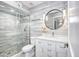 Modern bathroom featuring a glass shower, stylish vanity, and a round mirror at 1806 W Rosewood Ct, Chandler, AZ 85224