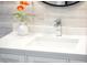 Close-up of a bathroom vanity with a modern faucet and a decorative flower arrangement at 1806 W Rosewood Ct, Chandler, AZ 85224