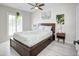 Cozy bedroom with a platform bed, ceiling fan, and natural light from the window at 1806 W Rosewood Ct, Chandler, AZ 85224
