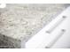 Close up on granite countertop with white cabinets and silver drawer pulls at 1806 W Rosewood Ct, Chandler, AZ 85224