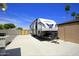 Long driveway with a trailer and gravel yard, great for RV parking and outdoor activities at 1806 W Rosewood Ct, Chandler, AZ 85224