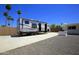 Long driveway with a trailer, palm trees, and a block fence, perfect for parking and privacy at 1806 W Rosewood Ct, Chandler, AZ 85224