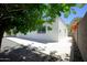 Back exterior view of a white home with a gravel yard, showing the clean lines and outdoor space at 1806 W Rosewood Ct, Chandler, AZ 85224
