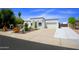 The house features a driveway, white paint, desert landscaping and an attached garage at 1806 W Rosewood Ct, Chandler, AZ 85224