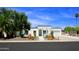 Inviting exterior showcasing the home's crisp white facade, arched entryway, and desert landscaping under a bright sky at 1806 W Rosewood Ct, Chandler, AZ 85224