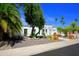 Front yard view of a white house framed by trees and desert landscaping elements at 1806 W Rosewood Ct, Chandler, AZ 85224