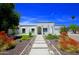 Charming white home with well-manicured desert landscaping and a stone walkway leading to the front door at 1806 W Rosewood Ct, Chandler, AZ 85224