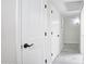 Hallway with white walls, white doors, and black hardware at 1806 W Rosewood Ct, Chandler, AZ 85224