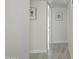 Bright hallway featuring light wood floors and fresh white walls, adorned with tasteful floral artwork at 1806 W Rosewood Ct, Chandler, AZ 85224