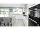 Bright kitchen featuring an island, white cabinetry, stainless steel appliances, and granite countertops at 1806 W Rosewood Ct, Chandler, AZ 85224