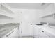 Clean laundry room with white washer and dryer, white cabinets, and granite countertops at 1806 W Rosewood Ct, Chandler, AZ 85224