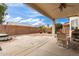 Inviting covered back patio featuring neutral-toned furniture, offering a relaxing outdoor space at 18131 W Addie Ln, Surprise, AZ 85374