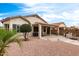 Lovely backyard featuring a covered patio, seating area, grill, and tasteful landscaping on a sunny day at 18131 W Addie Ln, Surprise, AZ 85374
