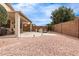 Serene backyard featuring a covered patio, comfortable seating, outdoor grill, and a charming fountain feature at 18131 W Addie Ln, Surprise, AZ 85374