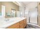 Bathroom featuring double sinks and walk-in shower at 18131 W Addie Ln, Surprise, AZ 85374