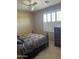 Comfortable bedroom with neutral walls, white shutters, ceiling fan, and carpeted floors at 18131 W Addie Ln, Surprise, AZ 85374