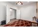 Spacious bedroom with bright white walls, featuring an adjacent room visible through an open door at 18131 W Addie Ln, Surprise, AZ 85374