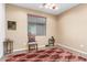 Bedroom with a ceiling fan, a comfortable chair, and decor accents, set against neutral-toned walls at 18131 W Addie Ln, Surprise, AZ 85374