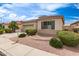 Charming single-story home features low-maintenance landscaping, tile roof, and two car garage at 18131 W Addie Ln, Surprise, AZ 85374