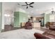 Open concept living space with vaulted ceilings, ceiling fan, and access to kitchen and dining at 18131 W Addie Ln, Surprise, AZ 85374