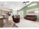 Open concept living space with vaulted ceilings, ceiling fan, and access to kitchen and dining at 18131 W Addie Ln, Surprise, AZ 85374