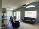 Open-concept living space featuring a kitchen, dining area, and living room with a sliding glass door to the backyard at 18131 W Addie Ln, Surprise, AZ 85374
