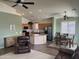 Open-concept living space featuring a kitchen, dining area, and living room with multiple fans and recessed lighting at 18131 W Addie Ln, Surprise, AZ 85374